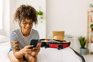 Beautiful woman with curly hair playing on her phone